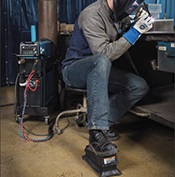 Welding operator TIG welding at bench using wireless foot control