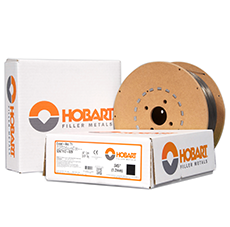Hobart Flux-cored filler metal on a spool sitting next to a box.