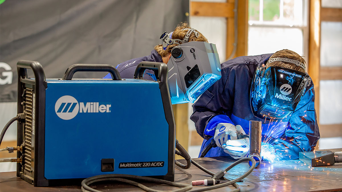 Two young welders practice motorsport fabrication by MIG welding metal tubing with a Multimatic 220 AC/DC welder
