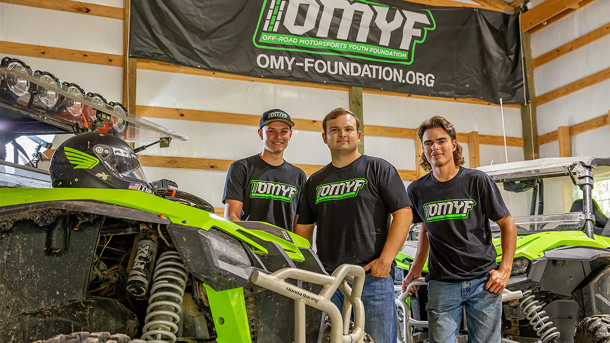 Preston Lewis with members of the Offroad Motorsports Youth Foundation and Baja motorsport racing vehicles
