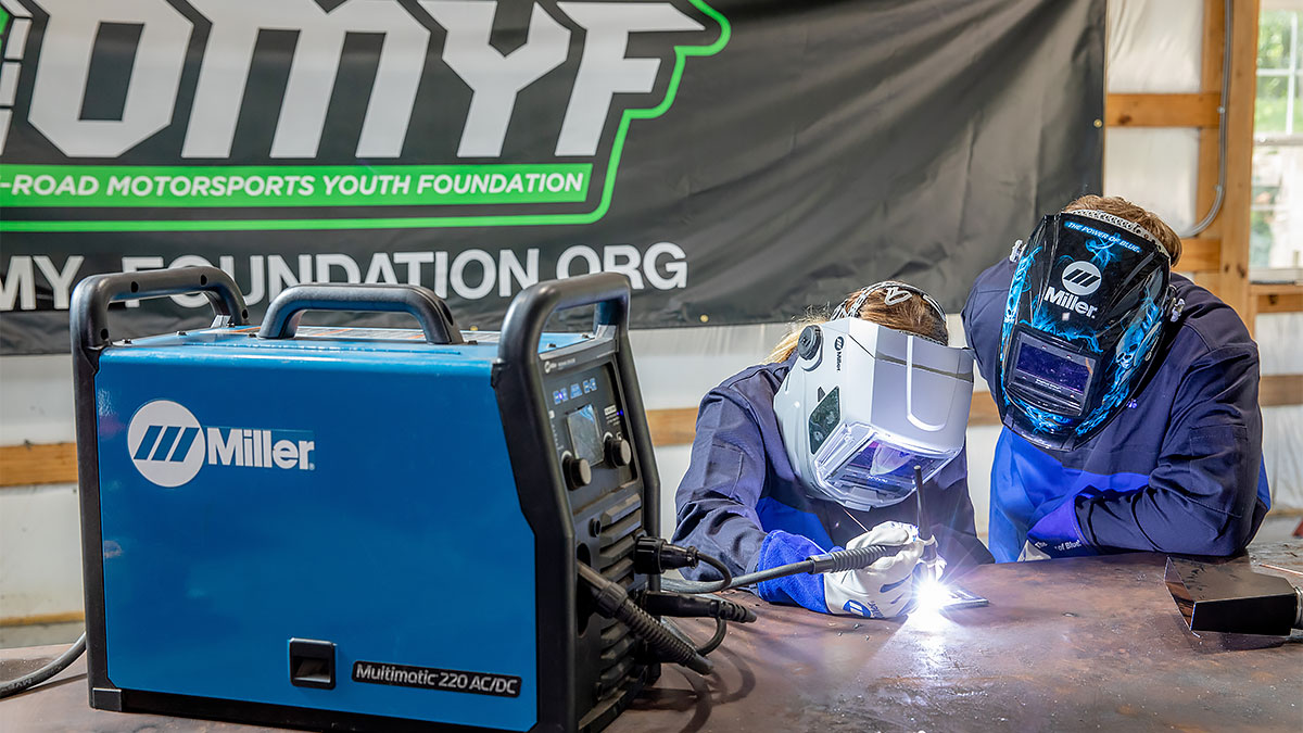 Two young welders practice motorsport fabrication by TIG welding metal plate with a Multimatic 220 AC/DC welder