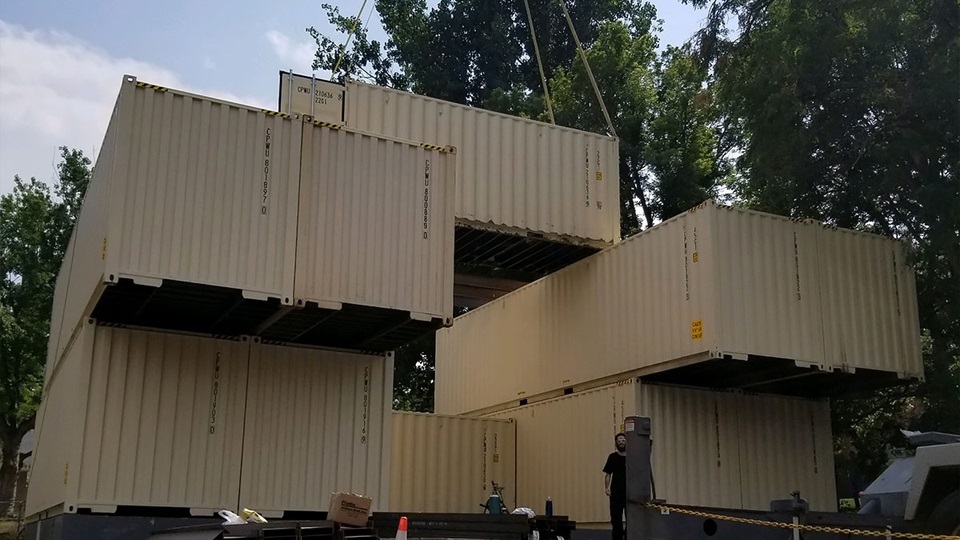 Crates being stacked for building shipping container home