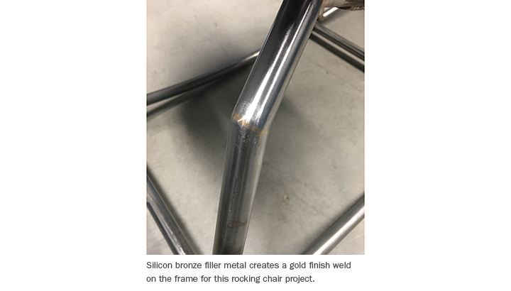 Silicon bronze filler metal creates a gold finish weld on the frame for this rocking chair project.