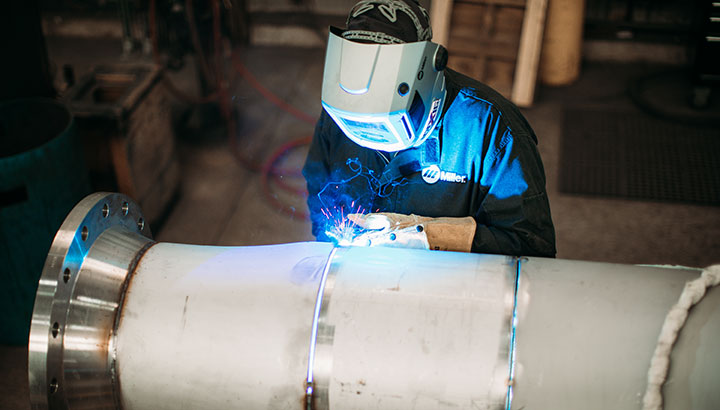 A welder uses the RMD process on stainless steel pipe