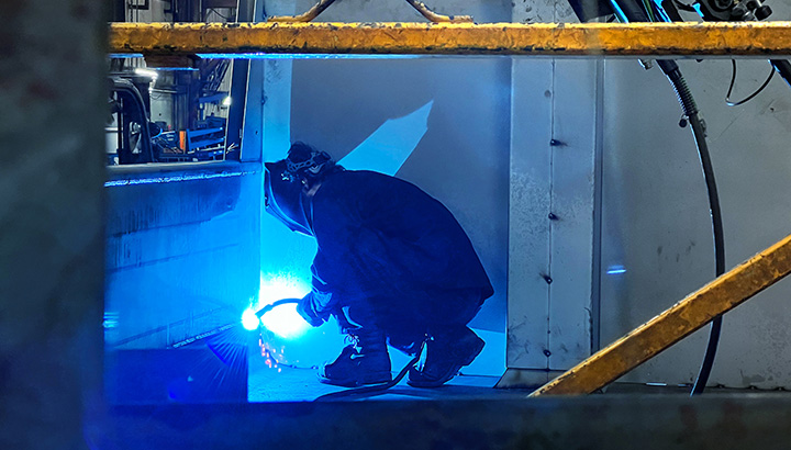 Operator welds with a wire process inside a truck body 