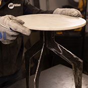 closeup of a side table with marble top and metal legs