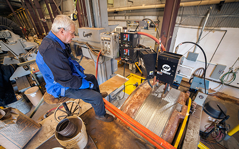 The shop uses Submerged Arc welding to get the penetration and deposition rate needed with larger jobs and thicker materials, such as build-up welding on a 7-foot-diameter rock crusher bowl. 
