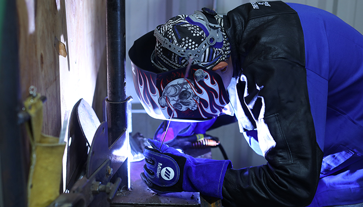 A student TIG welding at Blinn College