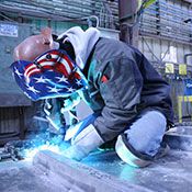 Welding operator welding on sheet metal in a manufacturing environment