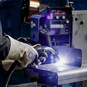 Close up of an operator MIG welding in a manufacturing environment 