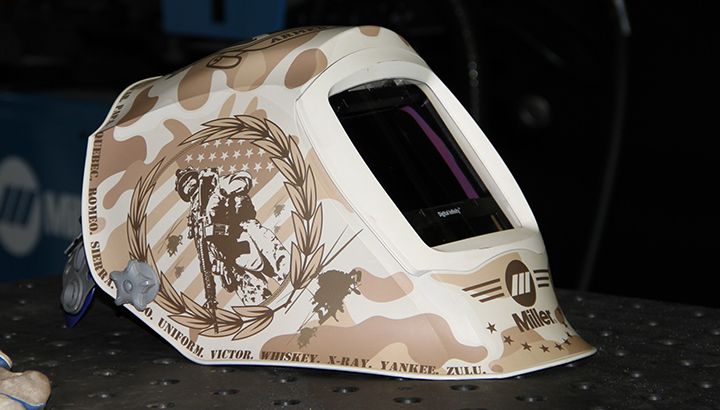 Closeup image of the camouflage Honor helmet sitting on a weld table