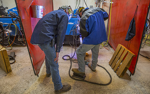 Team Fabricators employees pipe welding and observing