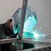 Student MIG welds in a shop