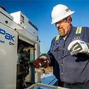 Service technician checks the oil in an EnPak A30 power system