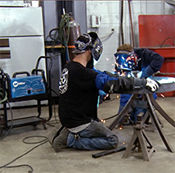 Michael Brandt welding with a kid