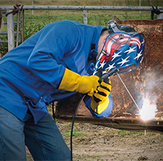 Image of man stick welding