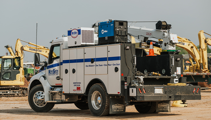 Rear view of engine-driven welder on the back of a work truck driving through a jobsite