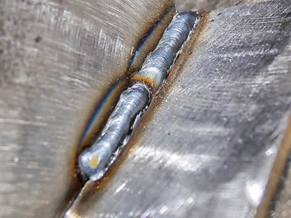 Closeup of convex weld with lack of fusion