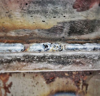 Closeup of weld with porosity