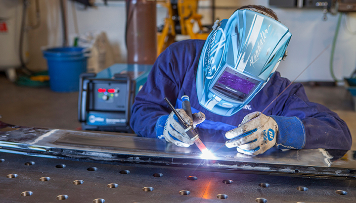 Welder TIG welding wearing Miller PPE