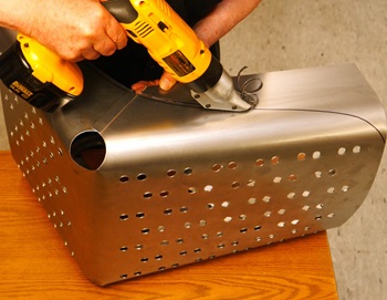 Cutting a sheet of metal with a cordless shear