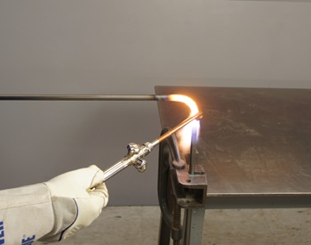 bending the leg of a stool with an oxy-acetylene torch