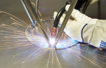 Welding a metal ring to stool legs