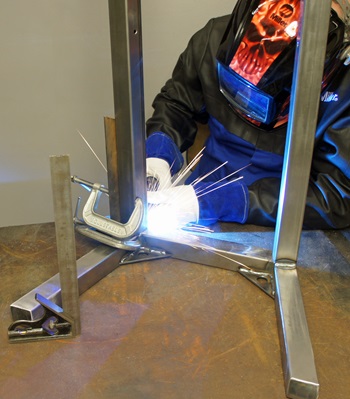 mig welding the legs onto a work platform