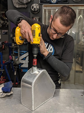 cutting a hole in the top of an aluminum fuel tank