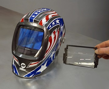Welding helmet next to magnifying lens for welding helmet