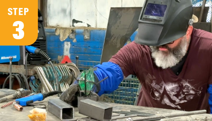 step 3: a welder looking at a piece of steel