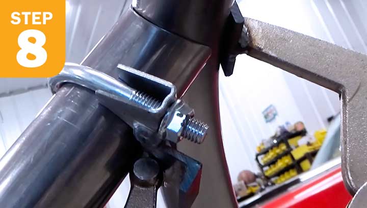 Image of the muffler clamp using rubber to help prevent denting.