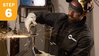 Grinding the top of a table bask with a sanding disk