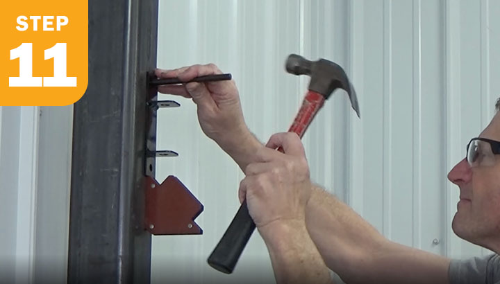 Transfer punching a hole into a steel post.