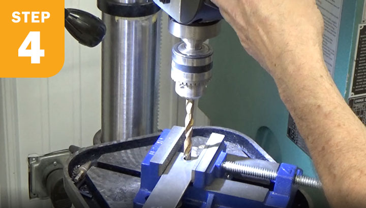 Drilling a hole on the mounting plate.