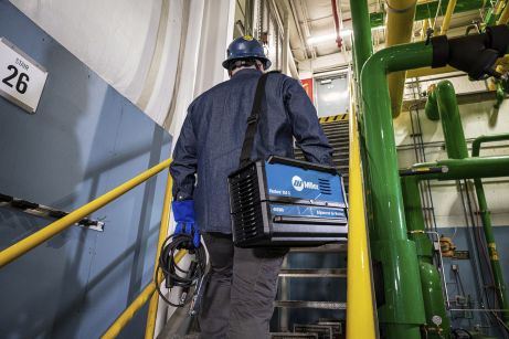 a man carrying the venture 150 S up stairs