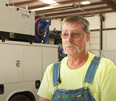 Larry Burns of Double R Utilities, Inc. standing in front of his EnPak A30