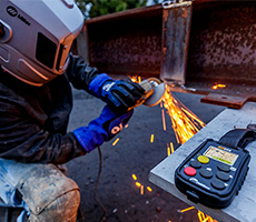 Image of someone grinding. A Wireless Interface Control remote is in the foreground.