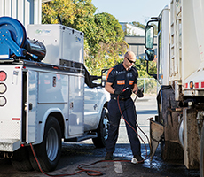A service truck mechanic uses an EnPak all-in-one power system