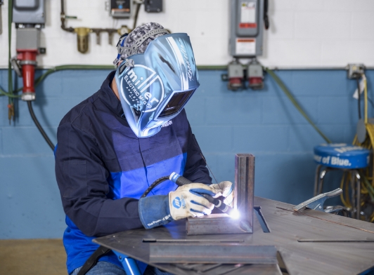 A person TIG welding using QuietPulse technology