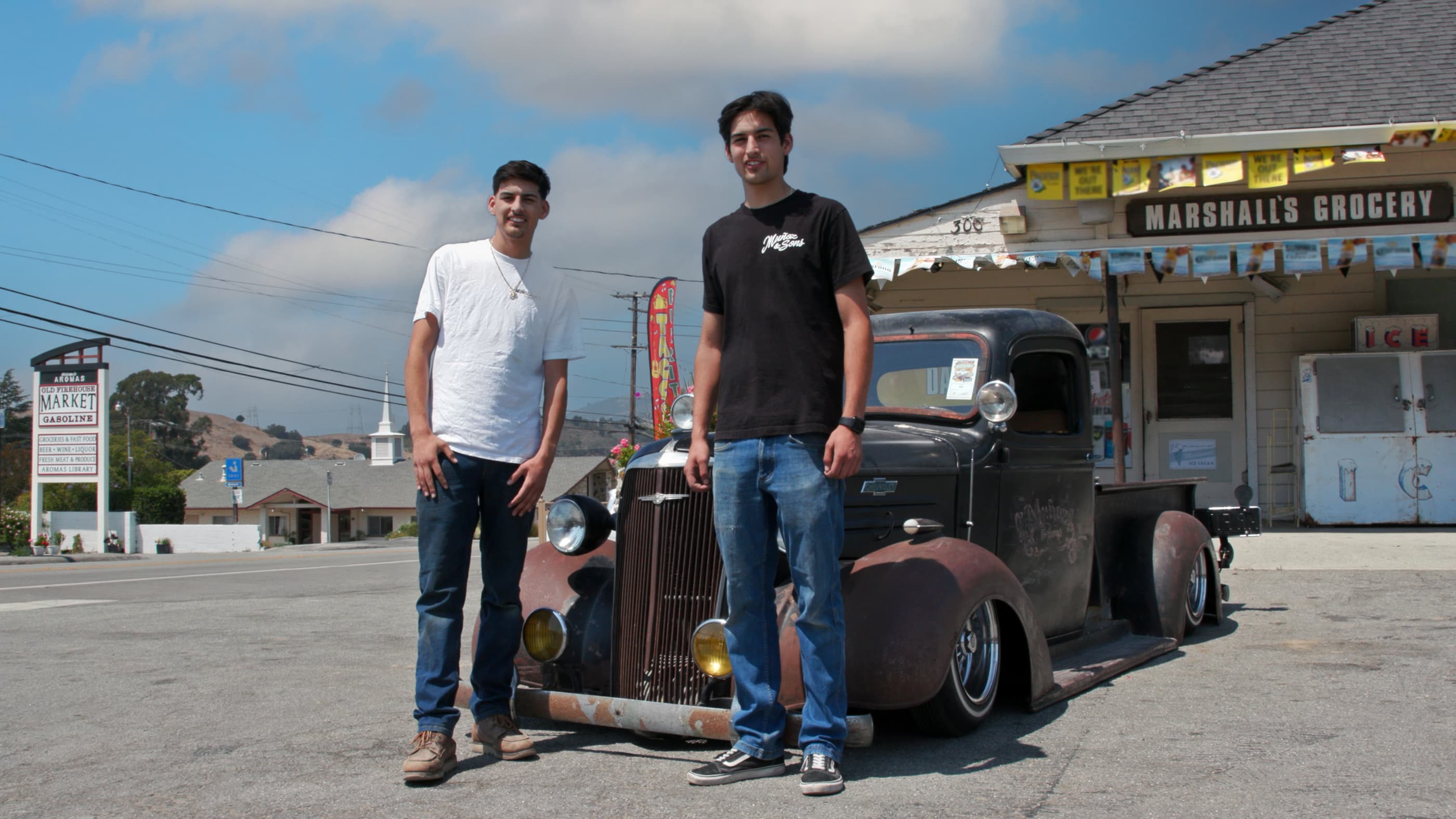 Two men standing in front of 1969 Datsun 510