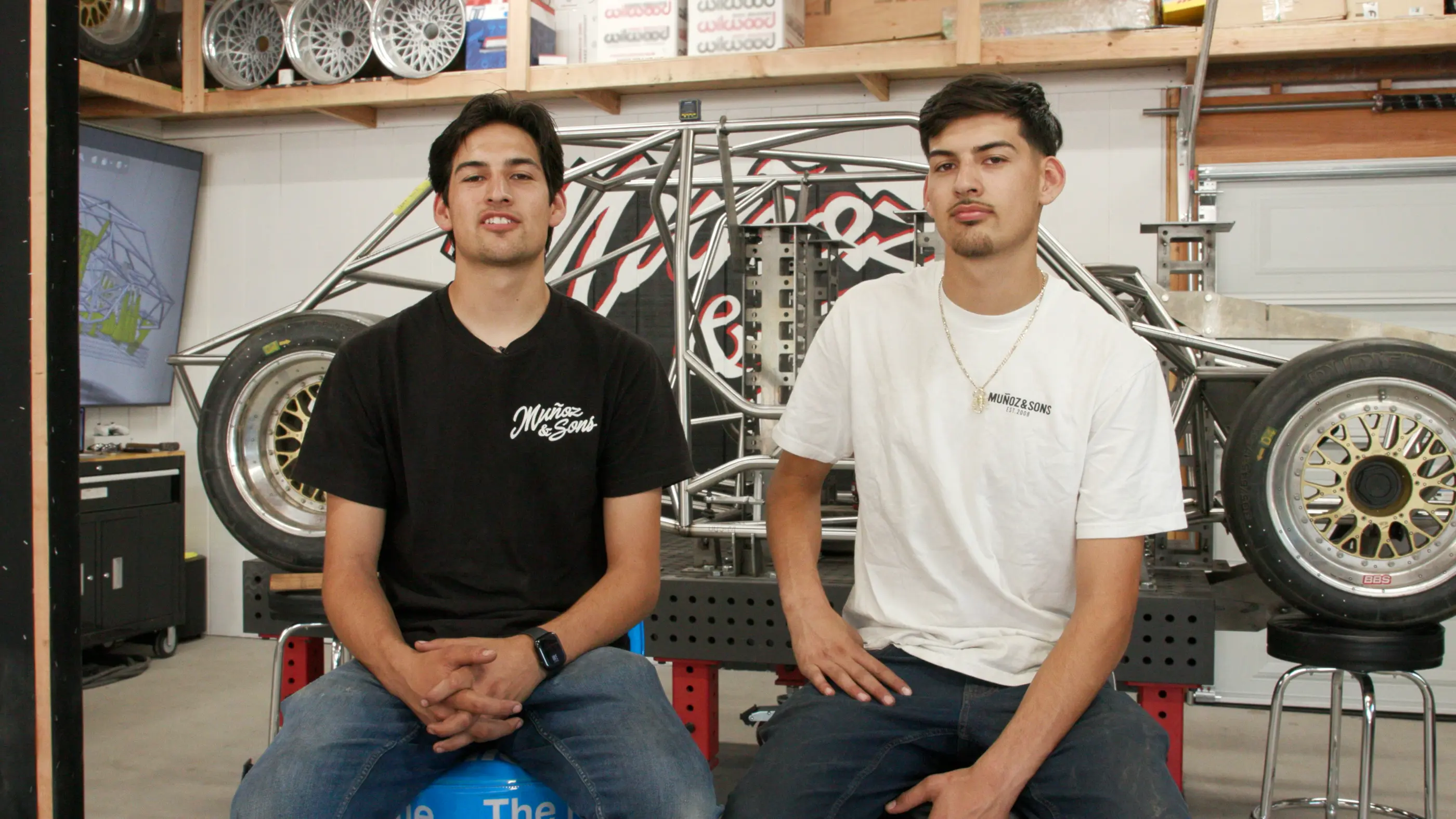 Two men sitting down looking at the camera