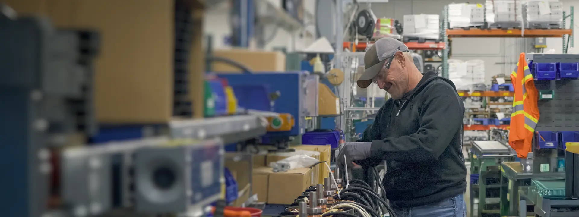A man assembling electrical cable components