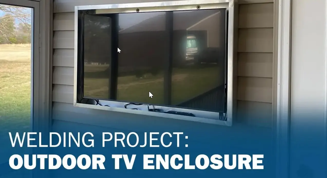 A flat-screen TV mounted in an outdoor enclosure. Text overlay reads 'Welding Project: Outdoor TV Enclosure' on a blue gradient.