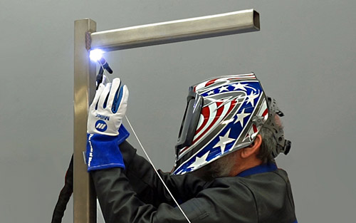 Photo of a welder overhead welding
