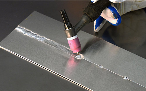 Photo of a welder fixing a weld