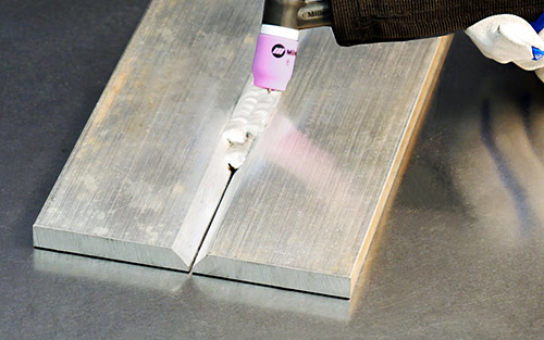 Close-up image of a deep v groove being filled in with multiple passes